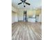 View of the living room with hardwood floors, open floor plan, and partial kitchen view at 5048 Orchid Springs St, Las Vegas, NV 89148