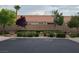 Neighborhood view featuring lush landscaping and well-maintained hedges at 5048 Orchid Springs St, Las Vegas, NV 89148