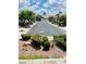 Street view featuring well-maintained landscaping, mature trees, and sidewalks on a sunny day at 5048 Orchid Springs St, Las Vegas, NV 89148