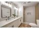 Spa-like bathroom with double vanity, quartz countertops, and a walk-in shower at 7910 Firethorn Ln, Las Vegas, NV 89123