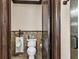 Elegant bathroom features a toilet and urinal at 10254 Sofferto Ave, Las Vegas, NV 89135