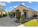 Beautiful home exterior featuring a covered patio with seating and a well-manicured lawn at 10254 Sofferto Ave, Las Vegas, NV 89135