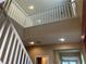 View of a staircase with white railings leading to the upper level, featuring recessed lighting and neutral wall colors at 11467 Monte Isola St, Las Vegas, NV 89141