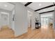 Light and bright hallway with wood flooring and architectural beams at 1705 Dream Canyon Ave, North Las Vegas, NV 89084