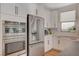 Stainless steel appliances and white shaker cabinets in this kitchen at 1705 Dream Canyon Ave, North Las Vegas, NV 89084