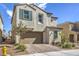 Two-story house with attached garage and landscaped front yard at 1934 Karner Blue Ave, North Las Vegas, NV 89031