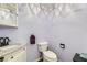 Small bathroom with granite vanity and updated toilet at 3245 W Landberg Ave, Las Vegas, NV 89141