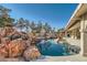 Inviting pool with a rock waterfall feature and a spacious patio area at 3245 W Landberg Ave, Las Vegas, NV 89141