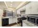 White kitchen with stainless steel appliances and granite countertops at 4045 Village Sq, Las Vegas, NV 89121