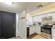 White kitchen cabinets, granite counters, and stainless steel appliances at 4045 Village Sq, Las Vegas, NV 89121