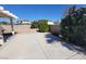 Large backyard with covered patio and desert landscaping at 5402 Night Swim Ln, Las Vegas, NV 89113