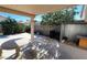 Backyard patio with covered seating area and landscaping at 5402 Night Swim Ln, Las Vegas, NV 89113