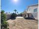 Spacious backyard with covered patio and desert landscaping at 5402 Night Swim Ln, Las Vegas, NV 89113