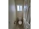 Clean bathroom with toilet and single window at 5402 Night Swim Ln, Las Vegas, NV 89113