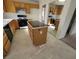 Kitchen with wooden cabinets, an island, and black appliances at 5402 Night Swim Ln, Las Vegas, NV 89113