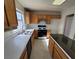 Kitchen with wooden cabinets, white countertops, and black appliances at 5402 Night Swim Ln, Las Vegas, NV 89113