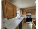 Kitchen with wooden cabinets, white countertops, and a double sink at 5402 Night Swim Ln, Las Vegas, NV 89113