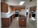 Kitchen with wooden cabinets, an island, and black appliances at 5402 Night Swim Ln, Las Vegas, NV 89113