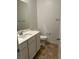Simple bathroom with white vanity and tile floor at 7368 N Decatur Blvd # 1, Las Vegas, NV 89131