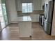 Modern kitchen with white cabinets, island, and stainless steel appliances at 7368 N Decatur Blvd # 1, Las Vegas, NV 89131