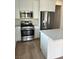 Modern kitchen featuring stainless steel appliances and white cabinetry at 7368 N Decatur Blvd # 1, Las Vegas, NV 89131