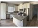 Open concept kitchen with island and stainless steel appliances at 7368 N Decatur Blvd # 1, Las Vegas, NV 89131