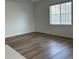 Spacious living room with hardwood floors and large window at 7368 N Decatur Blvd # 1, Las Vegas, NV 89131