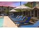 Inviting pool area with blue lounge chairs and umbrellas at 7368 N Decatur Blvd # 1, Las Vegas, NV 89131