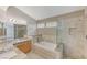 Bathroom features granite vanity, soaking tub, and glass shower at 7633 Falconwing Ave, Las Vegas, NV 89131