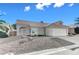 Single-story home with a two-car garage and desert landscaping at 7633 Falconwing Ave, Las Vegas, NV 89131