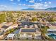 Aerial view of house with solar panels, pool, and mountain backdrop at 8229 Flowing Rapids Ct, Las Vegas, NV 89131