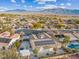 Aerial view of house with solar panels, pool, and mountain backdrop at 8229 Flowing Rapids Ct, Las Vegas, NV 89131