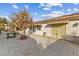 Large backyard with paved patio, mature tree, and access to home at 8229 Flowing Rapids Ct, Las Vegas, NV 89131