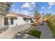 Backyard patio with grass patch, and access from sliding doors at 8229 Flowing Rapids Ct, Las Vegas, NV 89131