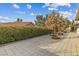 Spacious backyard with paved patio, greenery, and a view of neighboring homes at 8229 Flowing Rapids Ct, Las Vegas, NV 89131