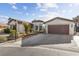 Single-story home with a two-car garage and desert landscaping at 8229 Flowing Rapids Ct, Las Vegas, NV 89131