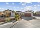 Single-story house with a two-car garage and neat landscaping at 8229 Flowing Rapids Ct, Las Vegas, NV 89131