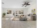 Inviting living room with neutral tones, tile floors, and abundant natural light at 8229 Flowing Rapids Ct, Las Vegas, NV 89131