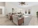 Bright living room with modern decor, ceiling fan, and double doors to the outside at 8229 Flowing Rapids Ct, Las Vegas, NV 89131