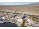 Aerial view of house, pool, and surrounding desert landscape at 8920 Mannix Ct, Las Vegas, NV 89143