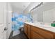 Bathroom with double sinks, wood cabinets, and a shower/tub combo at 8920 Mannix Ct, Las Vegas, NV 89143