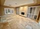 Large living room with tiled floors and white shutters at 10008 Rolling Glen Ct, Las Vegas, NV 89117