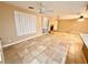 Open living room with tile floors, fireplace, and ceiling fan at 10008 Rolling Glen Ct, Las Vegas, NV 89117