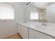 Bright bathroom with double sinks, large mirror, and shower at 10168 Maidens Wreath Ct, Las Vegas, NV 89183