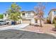 Two-story house with beige exterior, attached garage, and landscaping at 10168 Maidens Wreath Ct, Las Vegas, NV 89183