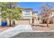 Two-story house with beige exterior, attached garage, and driveway at 10168 Maidens Wreath Ct, Las Vegas, NV 89183