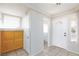 Foyer with wood cabinets, tiled floor, and a half bathroom at 10168 Maidens Wreath Ct, Las Vegas, NV 89183