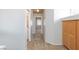 A long hallway with carpeted floors and access to bedrooms at 10168 Maidens Wreath Ct, Las Vegas, NV 89183