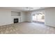 Bright living room featuring a fireplace and sliding glass door to backyard at 10168 Maidens Wreath Ct, Las Vegas, NV 89183