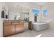 Elegant bathroom with soaking tub, dual sinks, and marble flooring at 11250 Torch Cactus Dr, Las Vegas, NV 89138